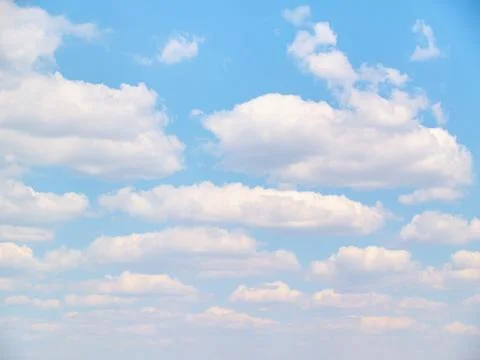 Soft vanilla clouds floating in the blue sky Stock Photos