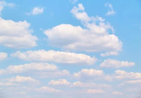 Soft vanilla clouds floating in the blue sky Stock Photos