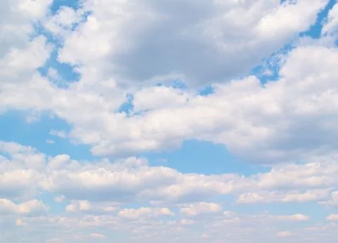 Soft vanilla clouds floating in the blue sky Stock Photos