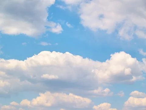 Soft vanilla clouds floating in the blue sky Stockfoto's