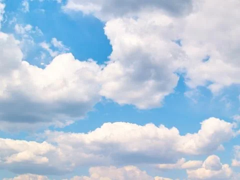 Soft vanilla clouds floating in the blue sky Stock Photos