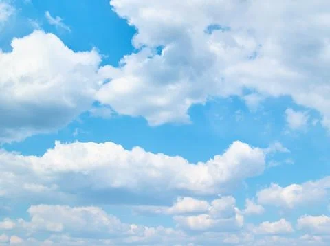 Soft vanilla clouds floating in the blue sky Stock Photos