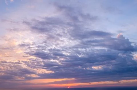 Soft violet clouds at Mediterranean sunset Stock Photos