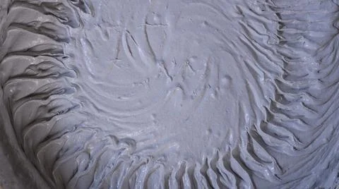 Soft, viscous gray construction mixture with a textured surface Stock Photos