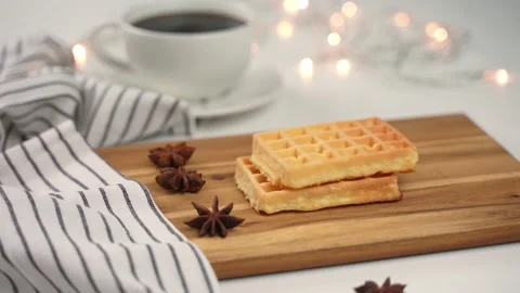 Soft waffles falling down on a wooden board. Stock Footage 168120723