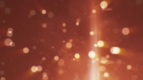 Soft warm bokeh lights and glowing rays on a reddish gradient background Stock Footage 323470875