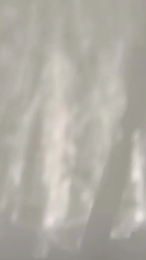 Soft water shadow ripple effect moving across a neutral wall, cinematic lig.. Stock Footage 346659370