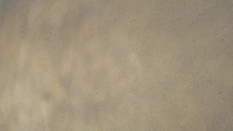 Soft water-like shadows ripple across a textured beige wall Stock Footage 337982858