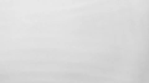 Soft water waves creating smooth arcs on a pale gray surface. Gentle movement Stock Footage 318924977