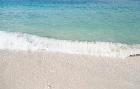 Soft wave of blue ocean on sandy beach. Stock Photos