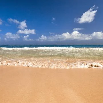 Soft Wave Of Blue Ocean On Sandy Beach. Background. Splash of waves on the sa Stock Photos