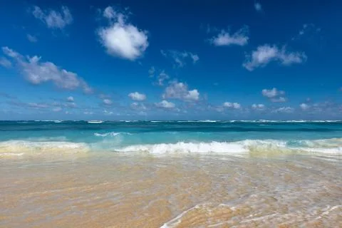 Soft Wave Of Blue Ocean On Sandy Beach. Background. Splash of waves on the sa Stock Photos