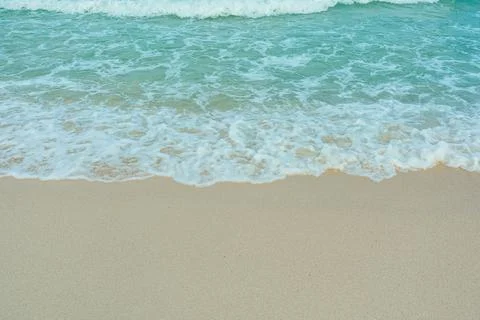 Soft wave of blue ocean on sandy beach. Summer vacation in island. clear az.. Stock Photos