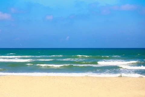 Soft wave of ocean on the sandy beach Stock Photos