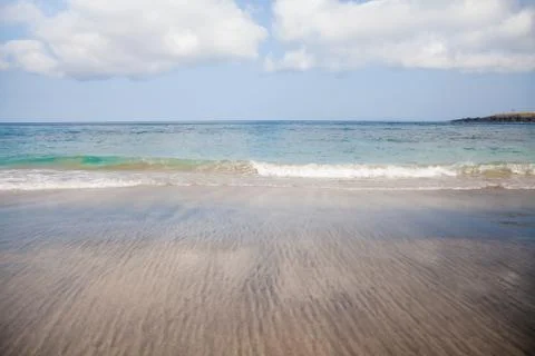 Soft wave of ocean on sandy beach, copy space, background. Stock Photos