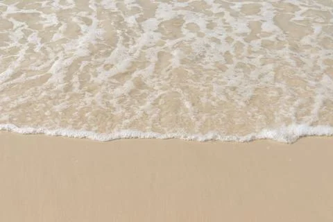 Soft wave  on sandy beach. Background. Stock Photos