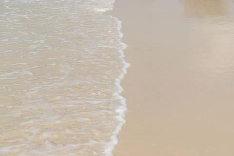 Soft wave  on sandy beach. Background. Stock Photos