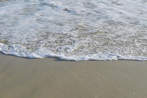 Soft wave on a sandy beach Stock Photos