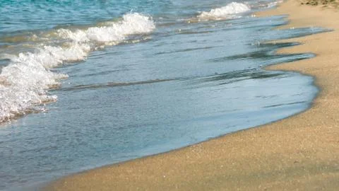 Soft wave of the sea with bubbles on a sandy beach. Holidays on the Red Sea Stock Photos