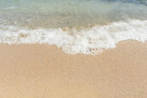 Soft wave of sea on empty sandy beach Background with copy space.. Stock Photos