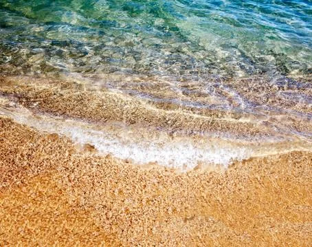 Soft wave of the sea on the sandy beach Stock Photos