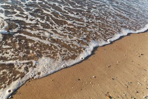 Soft wave of the sea on the sandy beach Stock Photos