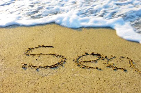 Soft wave of the sea on the sandy beach Stock Photos