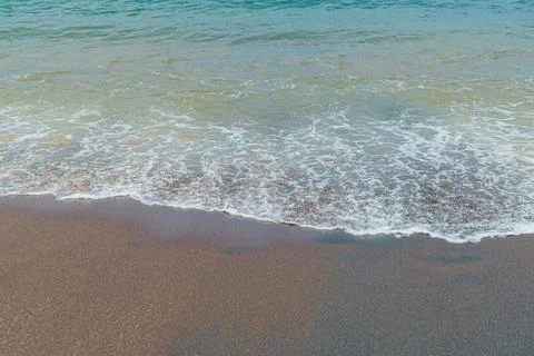 Soft wave of the sea on the sandy beach Stock Photos