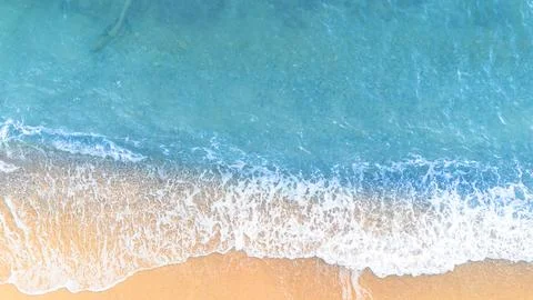 Soft wave of the sea on the sandy beach background. Top view. 스톡 사진