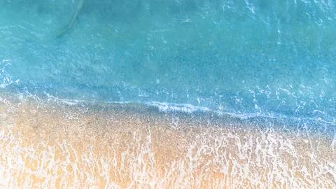 Soft wave of the sea on the sandy beach. Summer background. Stock Photos
