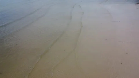 Soft waves of blue ocean on sandy beach background from top view from drones. Stock Footage 204898496