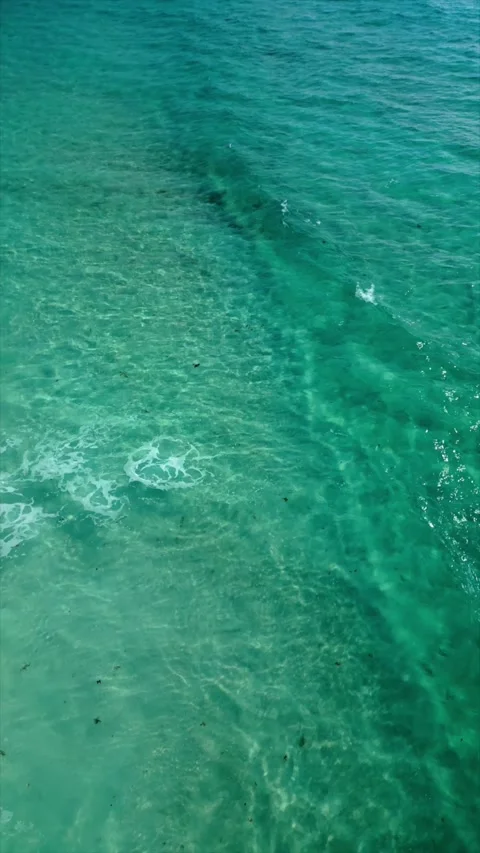 Soft waves breaking on the shore of a turquoise sea 스톡 동영상 342089631