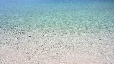 Soft waves on colorful sea. Waves breaking on shore. Pebble beach Stock Footage 155466077