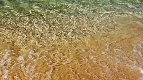 Soft waves with foam of blue ocean on the sandy beach Stock Footage 87812901