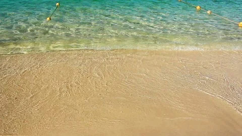 Soft waves with foam of blue ocean on the sandy beach Stock Footage 88316692