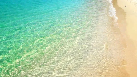 Soft waves with foam of blue ocean on the sandy beach   summer background. Stock Footage 89198881