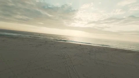 Soft waves meet sand at golden hour Stock Footage 340227482
