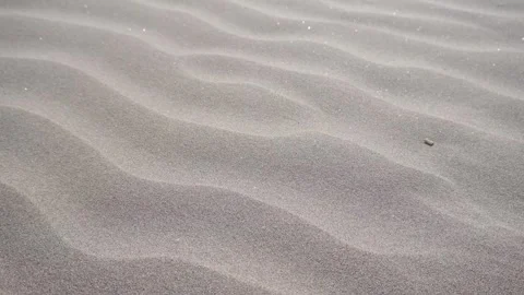 Soft waves ripple across the sand's surface. Stock Footage 347915499