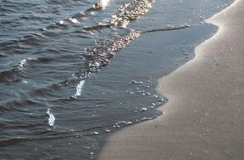 Soft waves on a sandy beach Stock Photos
