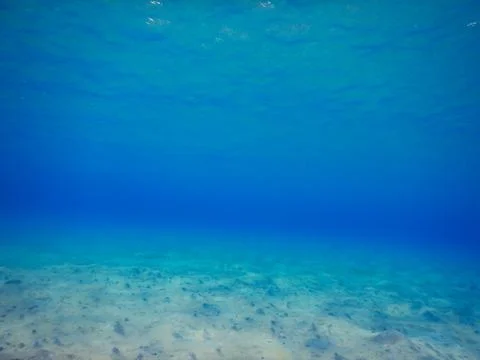 Soft waves at the surface and sandy seabed Stock Photos