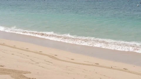 Soft waves washing over sandy beach. Beautiful sunny day at sea shore Stock Footage 139046647