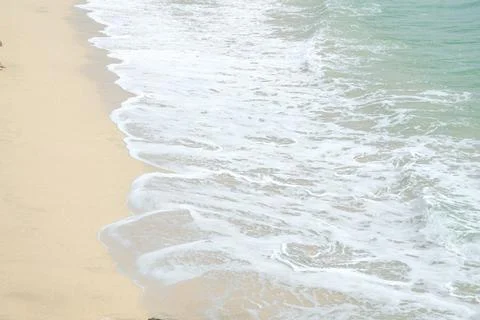 Soft Waves Washing Over the Sandy Shore, Shimmering Under the Bright Sunlig.. Stock Photos