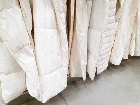 Soft white blankets in store or showroom Stock Photos