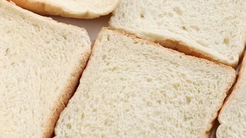 Soft white bread slices rotating slowly in a circle, showing fluffy interior and Stock Footage 310338366