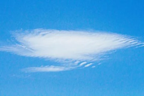 Soft White Cloud Floating Against A Bright Blue Sky On A Clear Day Stock Photos