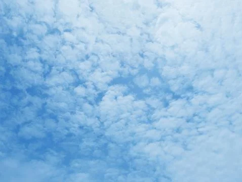 Soft white clouds against blue sky background. Stock Photos