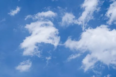Soft white clouds in a bright blue spring sky. Fotos de archivo