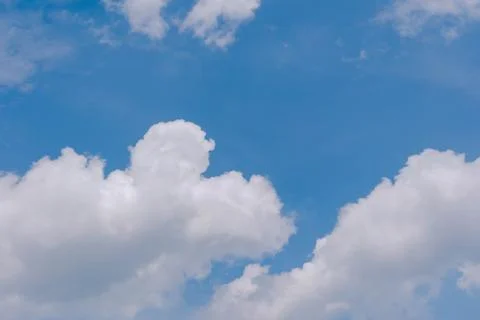 Soft white clouds in a bright blue sky Stock Photos