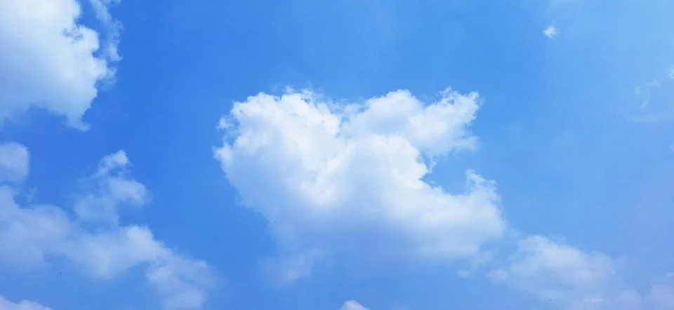 Soft White Clouds in Bright Blue Sky Background Stock Photos