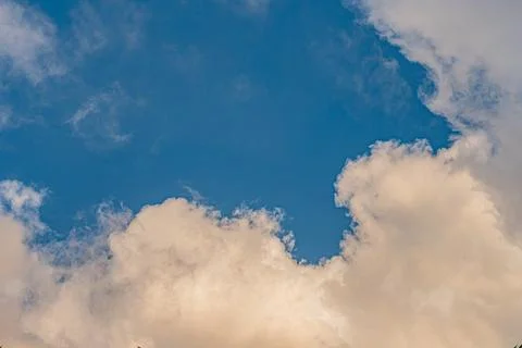 Soft white clouds fill most frame, casting shadows on each other Various text 写真素材